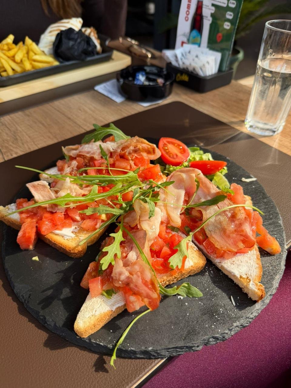 Gorilla bruschetti with prosciutto, tomato and arugula