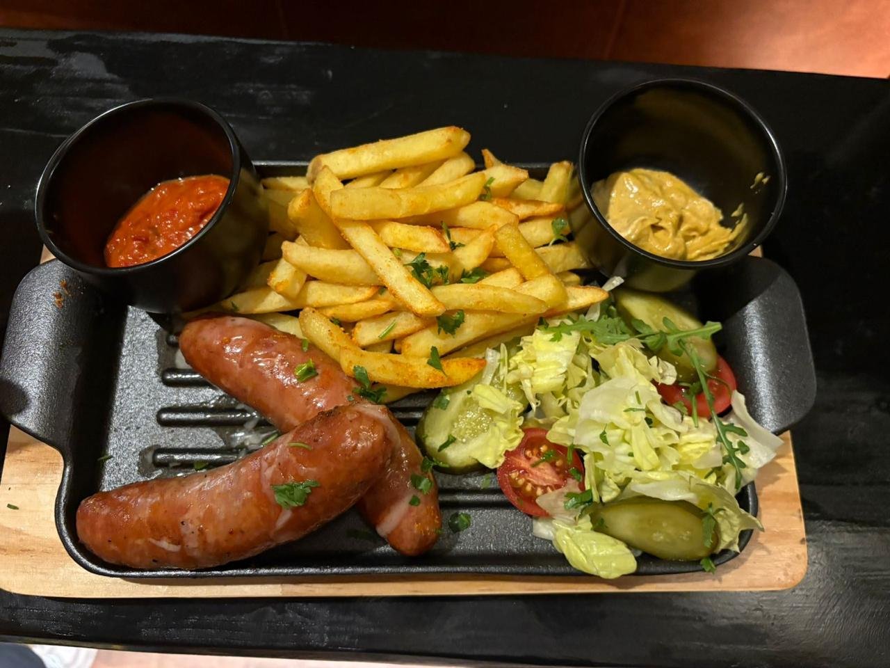 Grilled Austrian sausage with fries and fresh salad